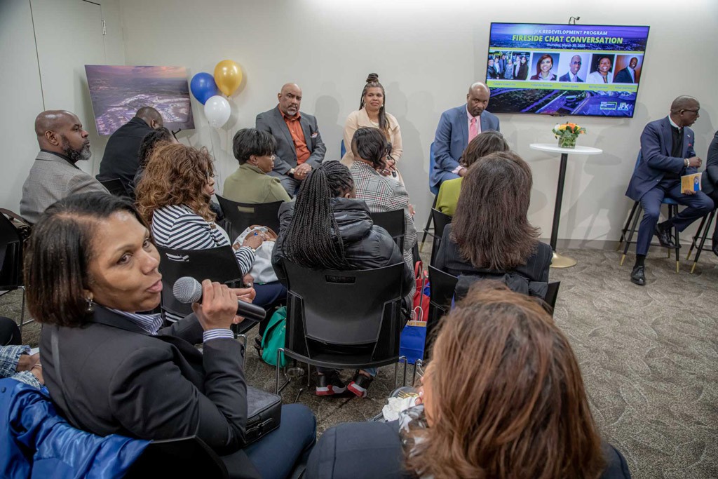 A group discussion at a fireside chat with participants sitting in audience and speakers on stage.