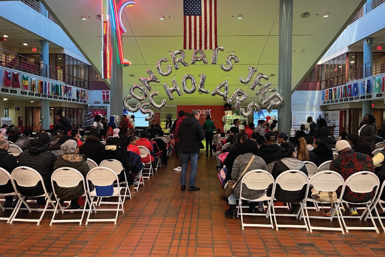 Group of graduates sitting with balloons in the background