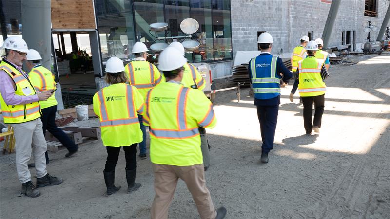 JMP staff in construction jackets and hardhats walking